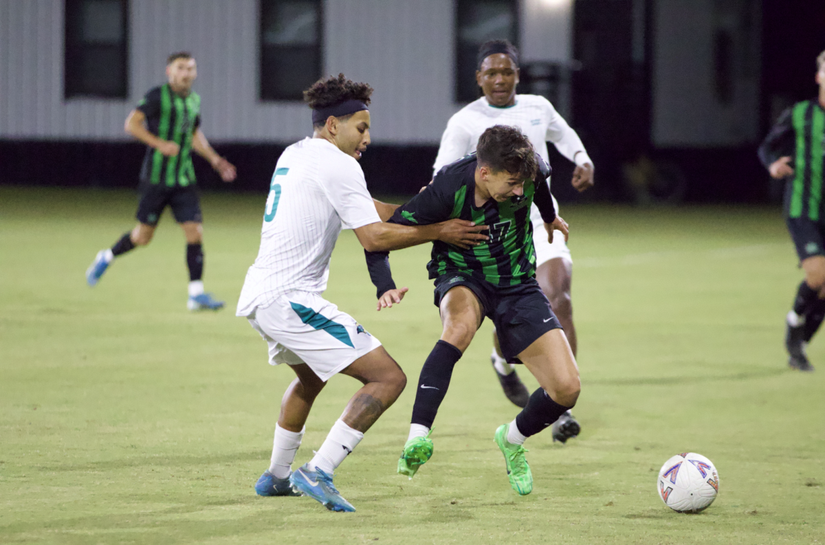 Leon Olacio, midfielder, attempts to gain possession from the Marshall offense. 